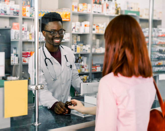a pharmacist assisting customer